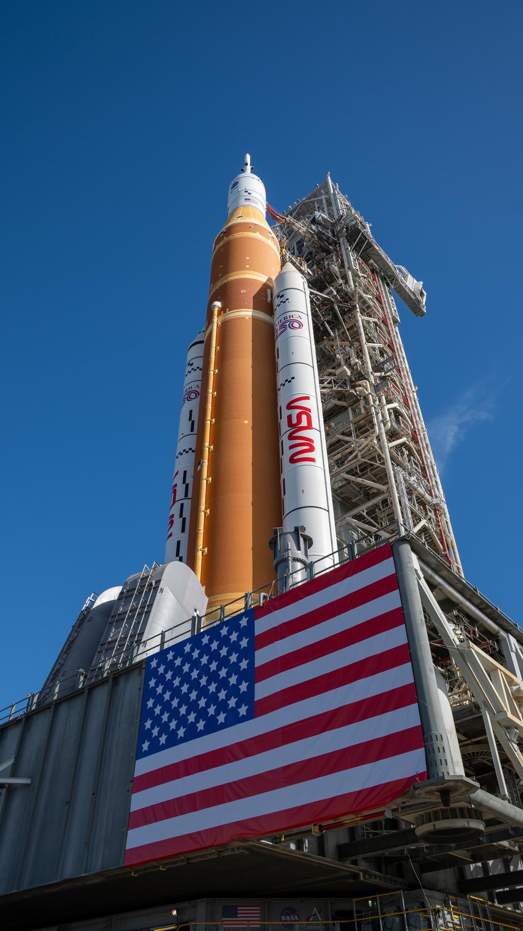 This image shows NASA’s SLS (Space Launch System) and Orion spacecraft rolling out of the Vehicle Assembly Building at NASA’s Kennedy Space Center. NASA's massive Crawler-Transporter, upgraded for the Artemis program, carries the powerful SLS rocket and Orion spacecraft on the Mobile Launcher from the Vehicle Assembly Building to Launch Pad 39B at Kennedy Space Center in preparation for the Artemis II mission.  